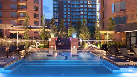 Seasons of Cherry Creek pool area with lounge chairs, fountains, and umbrellas.