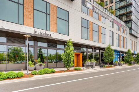 Cherry Creek sidewalk with lush landscaping and bustling store fronts like Matsuhisa.